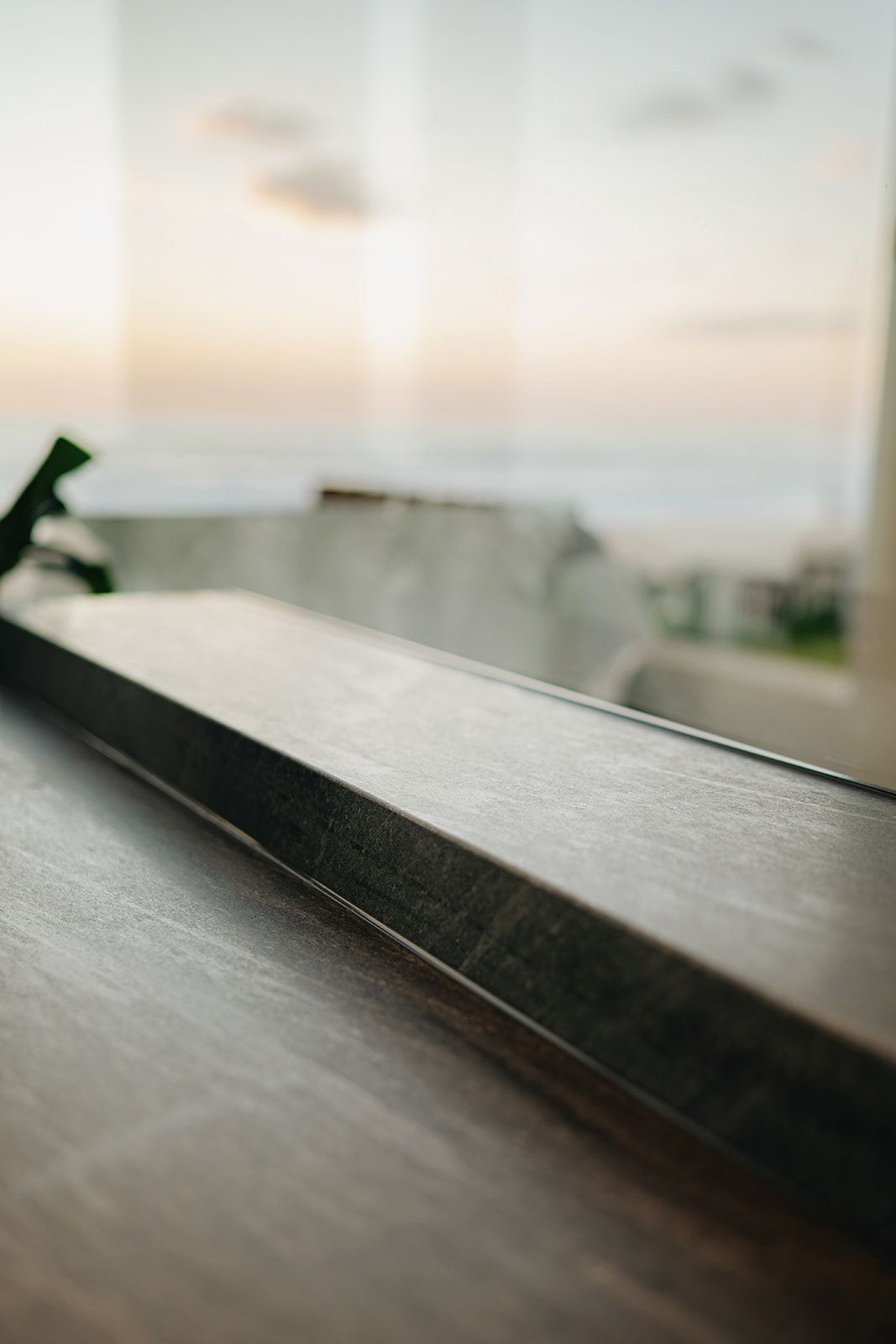 Detail of a sealed stone benchtop against ocean views