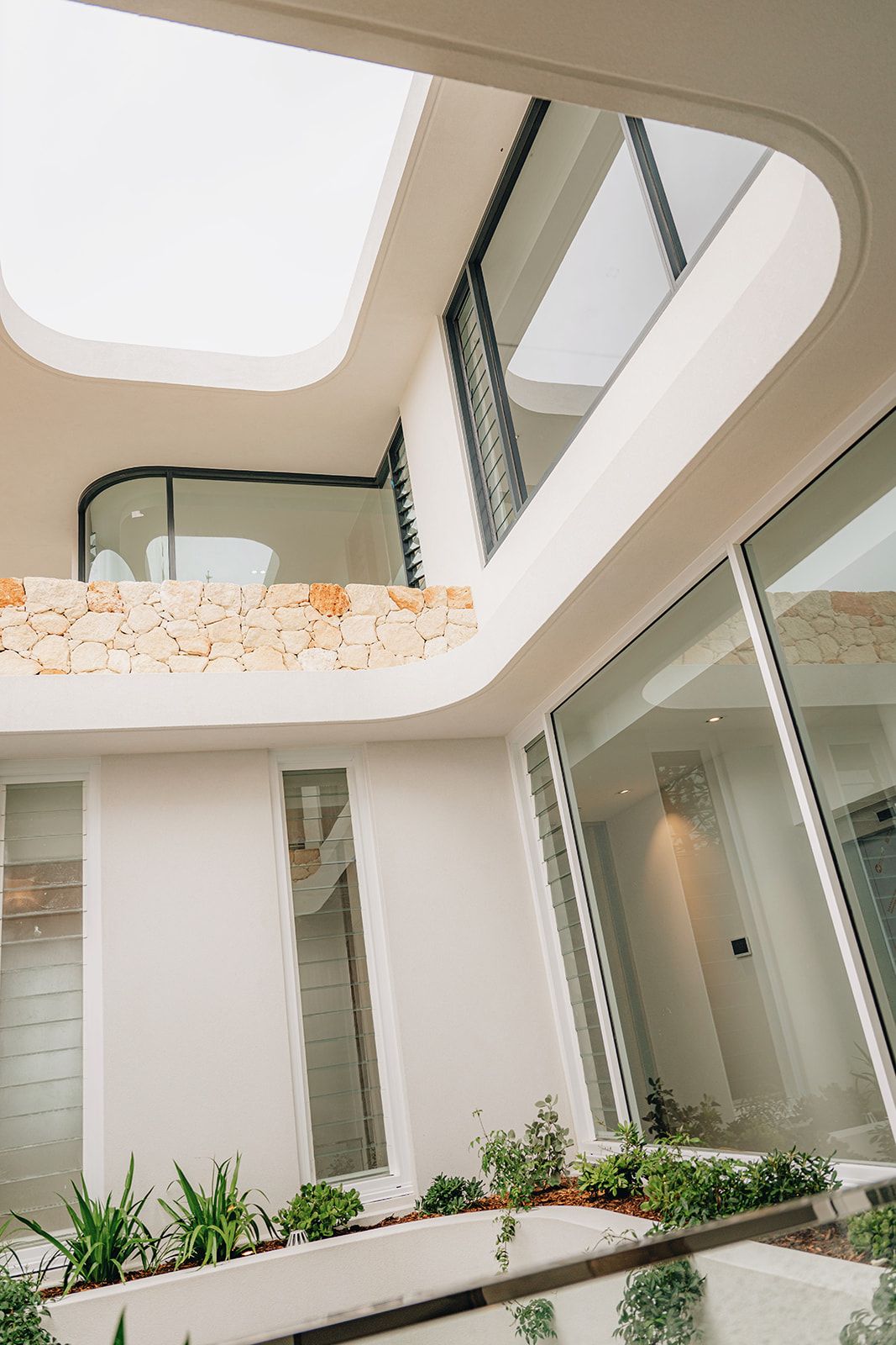 Stone and glass void with skylights on a luxury home